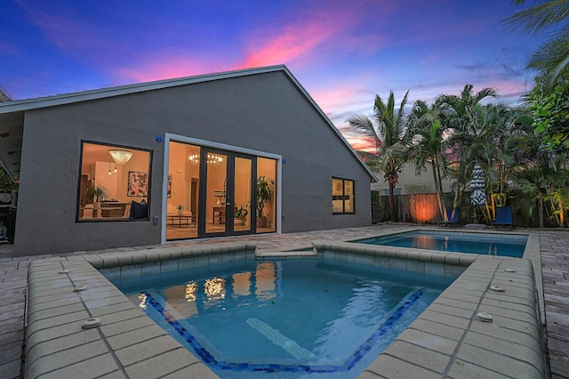 view of pool at dusk