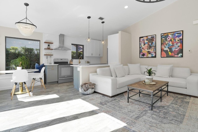 living room featuring light hardwood / wood-style floors, sink, and a chandelier