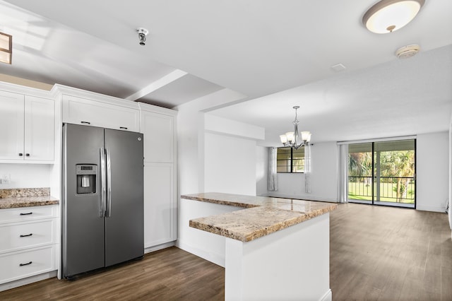 kitchen featuring white cabinetry, kitchen peninsula, stainless steel fridge, a notable chandelier, and light stone countertops