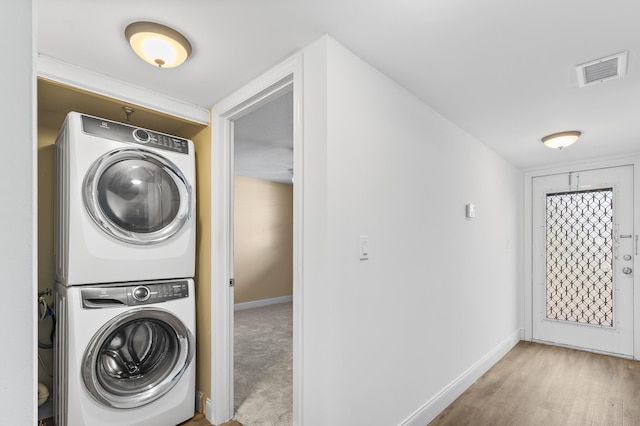 washroom with stacked washer / dryer