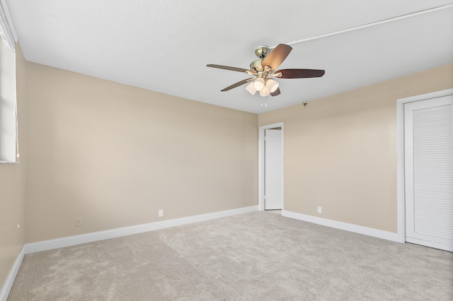 unfurnished bedroom with ceiling fan and light colored carpet