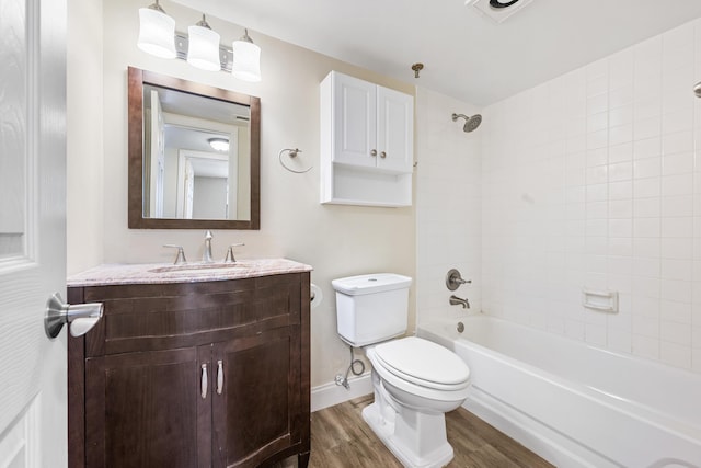 full bathroom with toilet, tiled shower / bath combo, hardwood / wood-style floors, and vanity