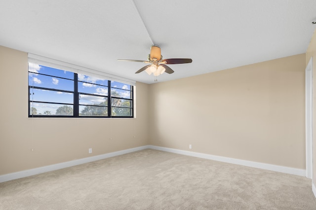 spare room with ceiling fan and carpet flooring