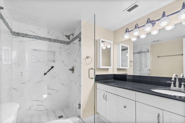 bathroom featuring an enclosed shower and vanity