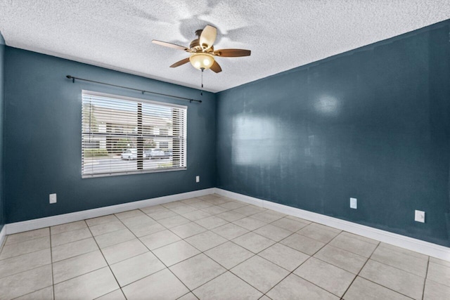 tiled spare room with ceiling fan and a textured ceiling