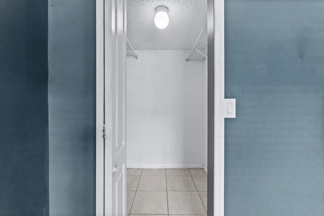 spacious closet with light tile patterned flooring