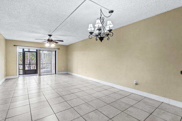 tiled empty room with ceiling fan with notable chandelier and a textured ceiling