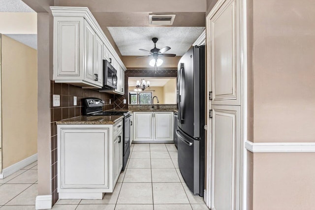 kitchen featuring white cabinets, dark stone countertops, and stainless steel appliances