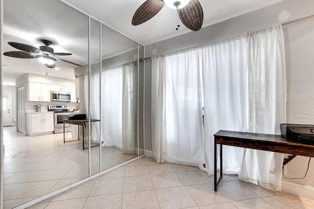 interior space featuring a textured ceiling and ceiling fan