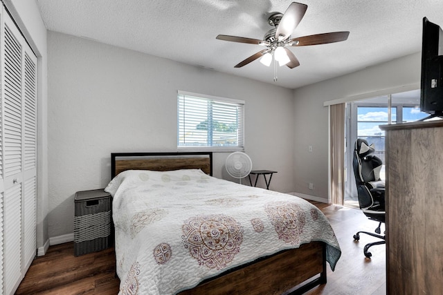 bedroom with ceiling fan, a closet, dark hardwood / wood-style flooring, and multiple windows