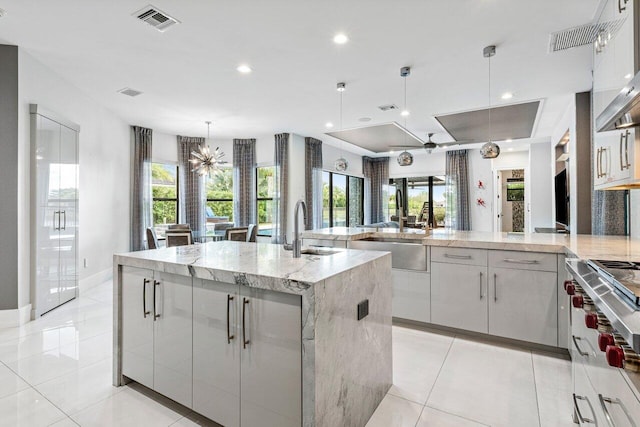 9748 Rennes Ln, Delray Beach, FL 33446 - kitchen featuring appliances with stainless steel finishes, modern cabinets, extractor fan, and visible vents