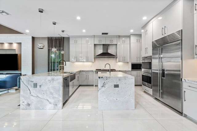 9748 Rennes Ln, Delray Beach, FL 33446 - kitchen with a sink, wall chimney exhaust hood, stainless steel appliances, visible vents, and modern cabinets