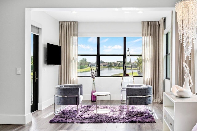 living area with a healthy amount of sunlight and light hardwood / wood-style floors