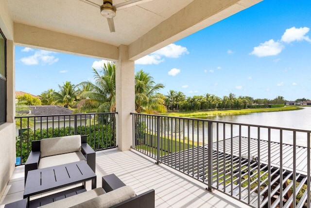 balcony featuring a water view, ceiling fan, and an outdoor living space