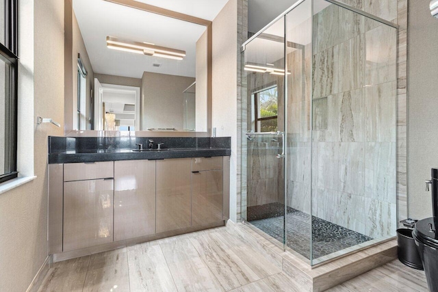 bathroom featuring vanity, hardwood / wood-style floors, a shower with door, and toilet