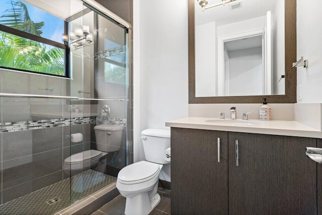 bathroom with an enclosed shower, vanity, tile patterned floors, and toilet