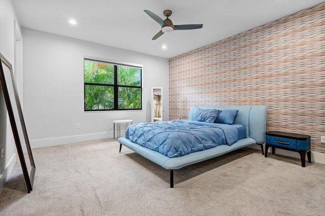 bedroom with ceiling fan and light colored carpet