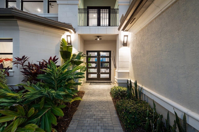 9748 Rennes Ln, Delray Beach, FL 33446 - property entrance with a balcony, stucco siding, and french doors