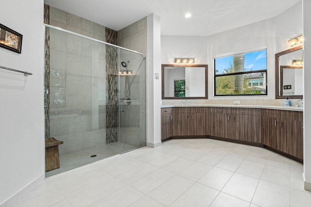 bathroom with vanity, an enclosed shower, and tile patterned flooring