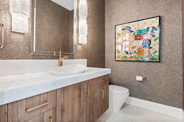 bathroom featuring vanity, tile patterned flooring, and toilet