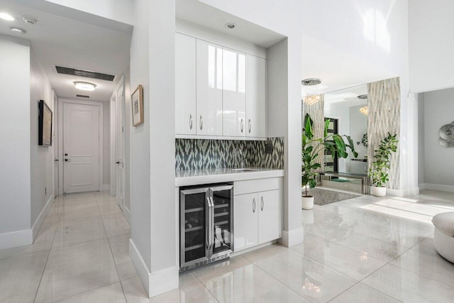9748 Rennes Ln, Delray Beach, FL 33446 - corridor featuring beverage cooler, baseboards, visible vents, and light tile patterned flooring
