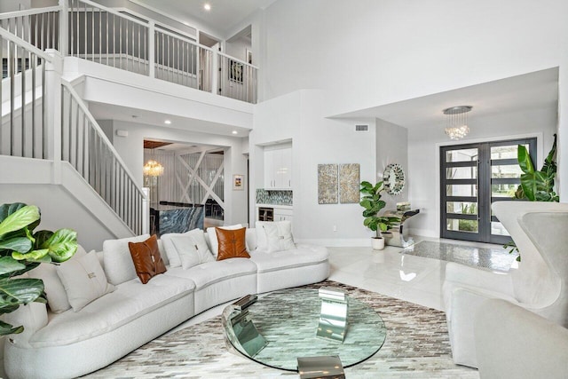 living room with an inviting chandelier and a high ceiling