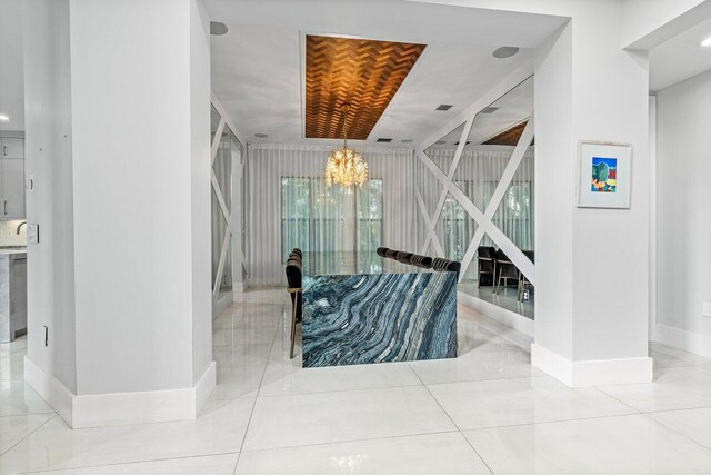 9748 Rennes Ln, Delray Beach, FL 33446 - tiled living area with visible vents, baseboards, a chandelier, a high ceiling, and stairs