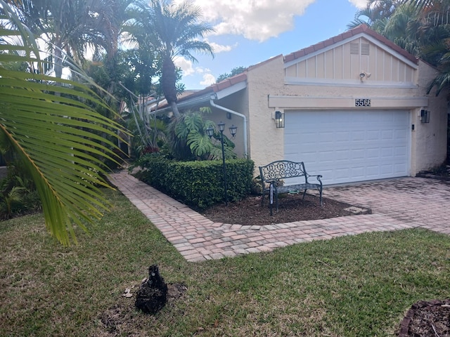 view of side of property with a yard and a garage