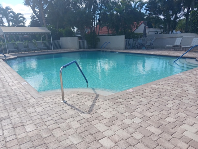 view of swimming pool with a patio area