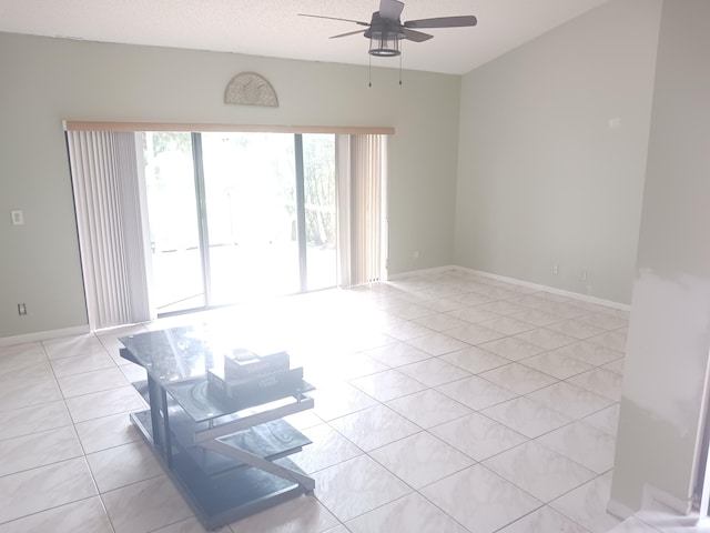 unfurnished room featuring ceiling fan and light tile patterned floors