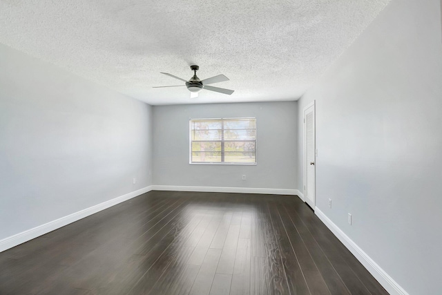 empty room featuring ceiling fan, a textured ceiling, baseboards, and dark wood-style flooring