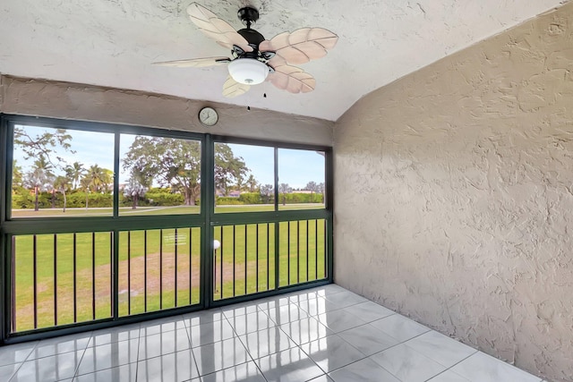 unfurnished sunroom with vaulted ceiling and ceiling fan