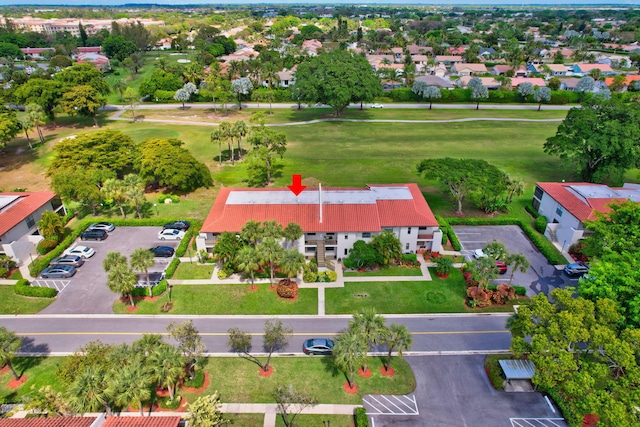 birds eye view of property with view of golf course and a residential view