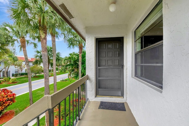 entrance to property featuring stucco siding