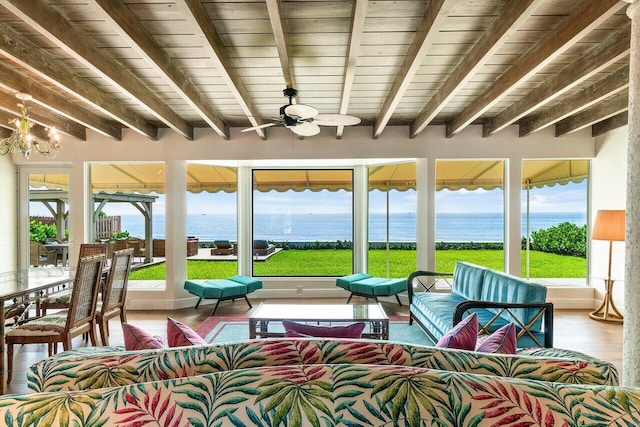 sunroom featuring a water view, ceiling fan, wood ceiling, and beamed ceiling