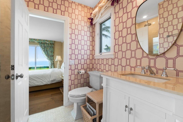 bathroom featuring toilet, vanity, and tile patterned flooring