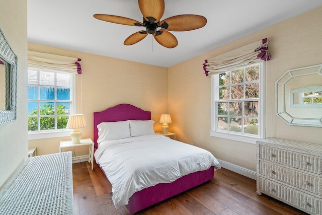 bedroom with ceiling fan and dark hardwood / wood-style floors