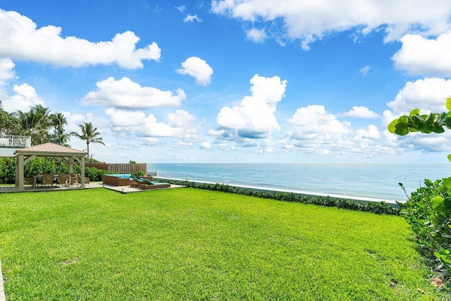 view of yard featuring a gazebo, a beach view, a water view, an outdoor hangout area, and a patio