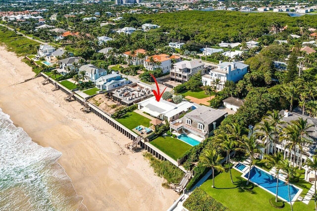 aerial view with a water view and a view of the beach