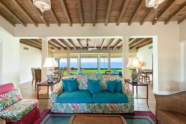 living room featuring hardwood / wood-style flooring, wooden ceiling, ceiling fan, vaulted ceiling with beams, and a water view