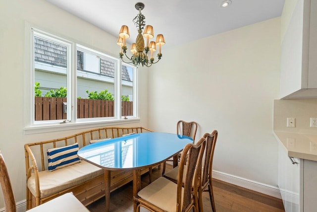 dining area with a notable chandelier and hardwood / wood-style floors