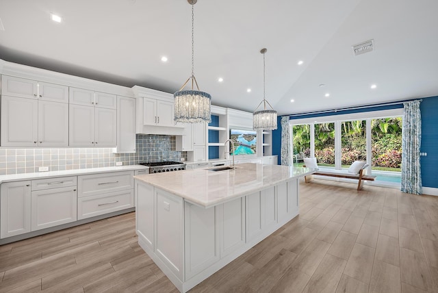 189 Shelter Ln, Jupiter Inlet Colony, FL 33469 - kitchen with a sink, visible vents, an inviting chandelier, white cabinetry, and stove