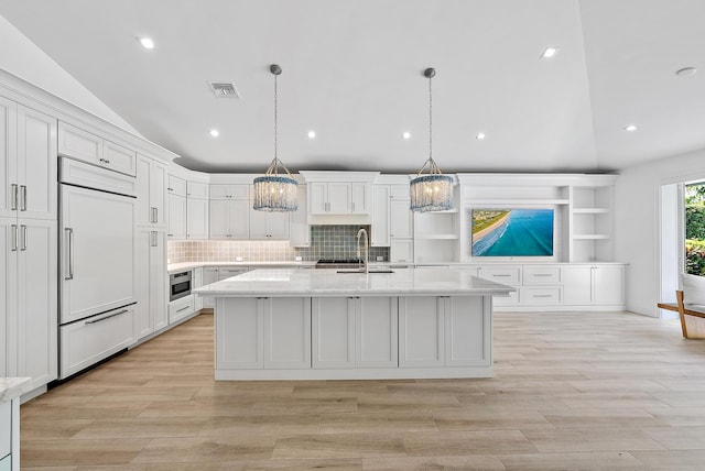 189 Shelter Ln, Jupiter Inlet Colony, FL 33469 - kitchen featuring vaulted ceiling, paneled refrigerator, a chandelier, white cabinets, and open shelves