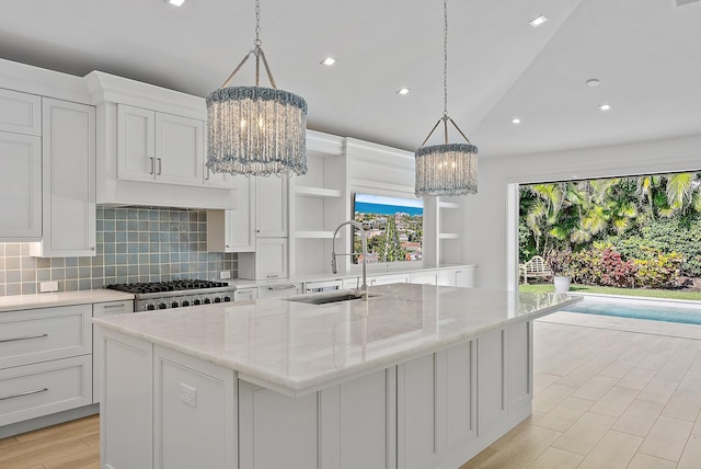189 Shelter Ln, Jupiter Inlet Colony, FL 33469 - kitchen featuring a chandelier, open shelves, tasteful backsplash, an island with sink, and recessed lighting