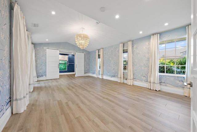 189 Shelter Ln, Jupiter Inlet Colony, FL 33469 - interior space with wallpapered walls, light wood-style flooring, lofted ceiling, a notable chandelier, and visible vents