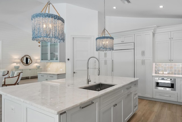 189 Shelter Ln, Jupiter Inlet Colony, FL 33469 - kitchen featuring a chandelier, vaulted ceiling, decorative backsplash, stainless steel oven, and recessed lighting