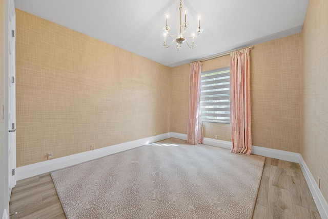 189 Shelter Ln, Jupiter Inlet Colony, FL 33469 - unfurnished room featuring wood finished floors, baseboards, and an inviting chandelier