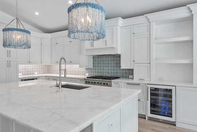 189 Shelter Ln, Jupiter Inlet Colony, FL 33469 - kitchen featuring a chandelier, open shelves, beverage cooler, backsplash, and lofted ceiling