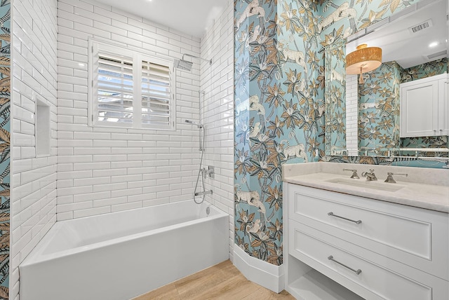 189 Shelter Ln, Jupiter Inlet Colony, FL 33469 - full bath featuring wallpapered walls, wood finished floors, visible vents, vanity, and  shower combination
