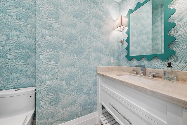 189 Shelter Ln, Jupiter Inlet Colony, FL 33469 - bathroom featuring wallpapered walls, baseboards, vanity, and toilet